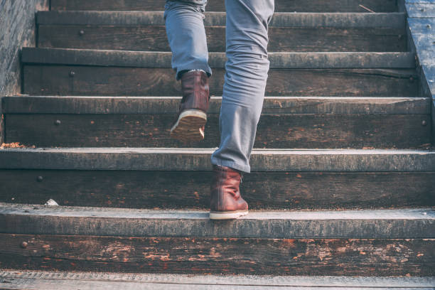 Walking upstairs: close-up view of man's brown leather shoes