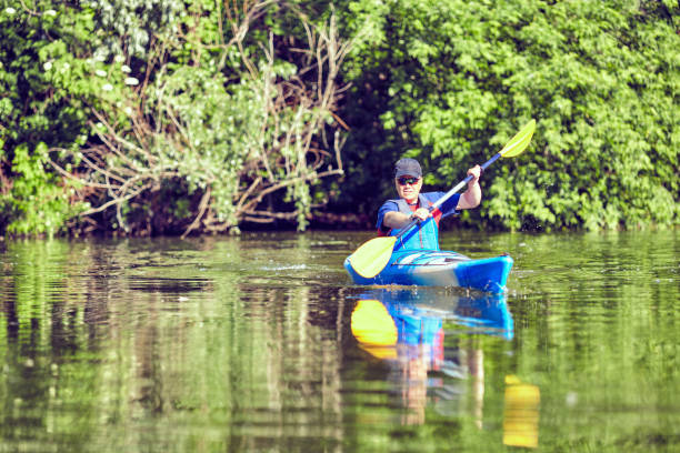 istock Man paddling a kayak on summer day. 934649876