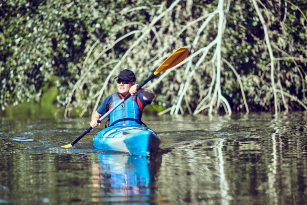 istock Man paddling a kayak on summer day. 934649882