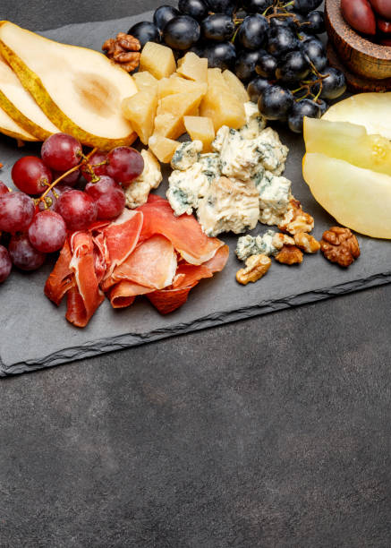 istock Meat plate antipasti snack - Prosciutto ham, blue cheese, melon, grapes, Olives 934652384