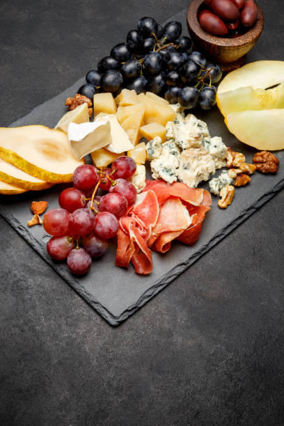 istock Meat plate antipasti snack - Prosciutto ham, blue cheese, melon, grapes, Olives 934652486