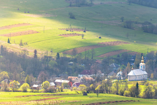 istock Church and village in green spring mountain valley 934652726