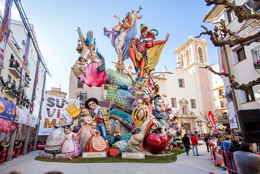 Valencia, Spain – March, 16, 2018: Las Fallas, papermache models are displayed during traditional celebration in praise of St Joseph, in Valencia, Spain. The term Falles refers to both the celebration and the monuments burnt at the end of the festivity. Celebration is annual, and it was declared a UNESCO World Heritage in 2017. This falla is in Pilar square, and its theme is about \