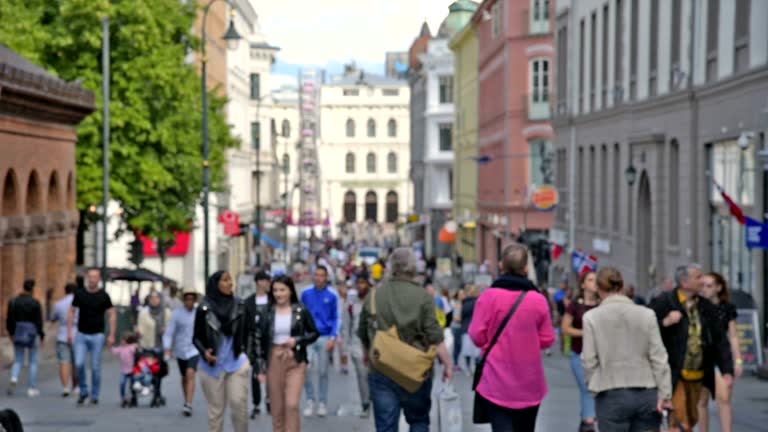 View of Oslo City Hall and street scene with people and traveller / Oslo, Norway
