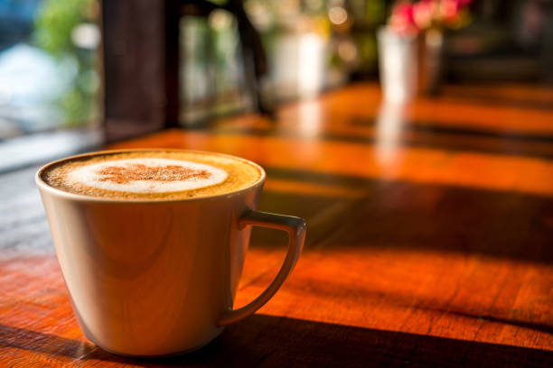istock Cappuccino coffee in the white cup on wooden table 934670018