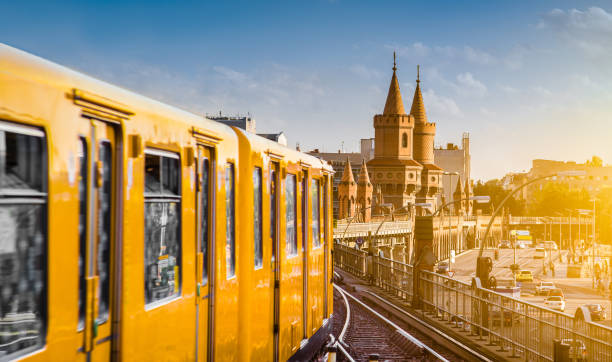 Berliner U-Bahn with famous Oberbaum Bridge in the background in beautiful golden evening light at sunset, Berlin Friedrichshain-Kreuzberg, Germany