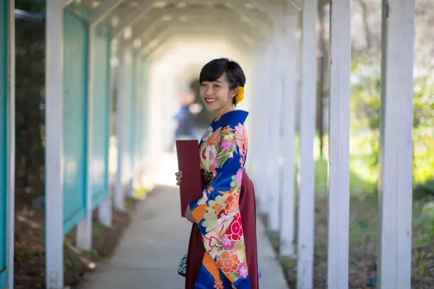 Young woman in hakama looking over shoulder - graduation day