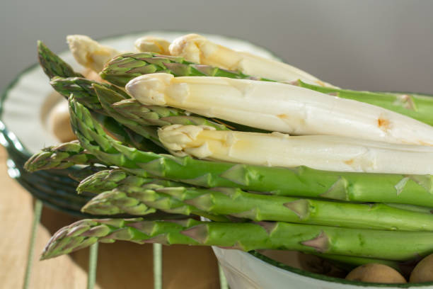 istock Raw uncooked fresh white and green asparagus with small potatoes, ready to cook for dinner 934690710