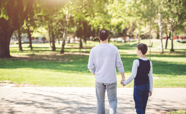 istock Father And Son In Park 934693130