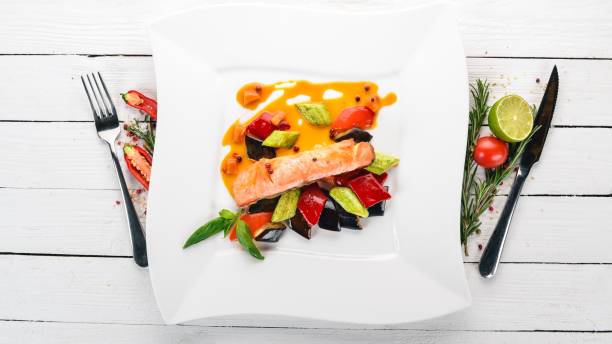 istock Baked Salmon Steak with Vegetables. On a wooden background. Top view. Copy space. 934696482