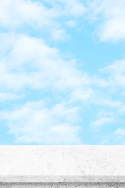 istock Empty white cement table over blue sky nature background, product display montage 934701514