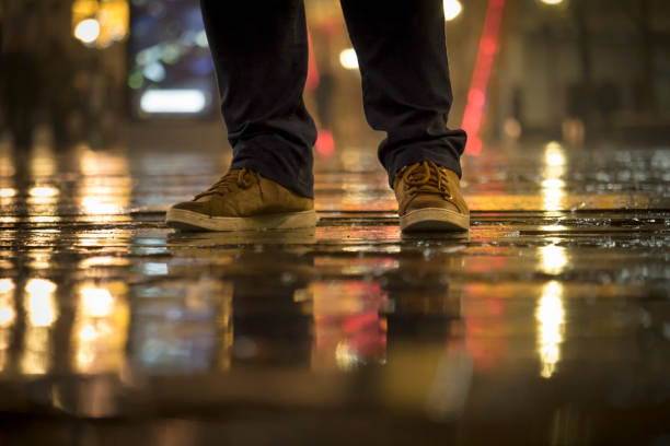 istock Man standing on the street  in the rain 934701928
