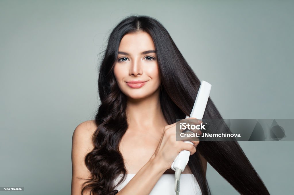 Attractive Woman With Curly Hair And Long Straight Hair Using Hair  Straightener Hair Problem And Haircare Concept Stock Photo - Download Image  Now - iStock