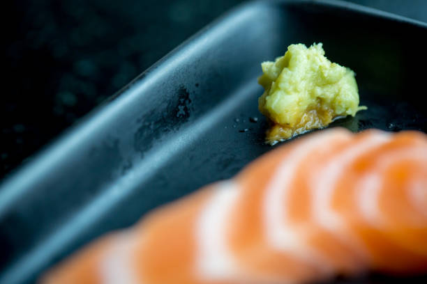 Fresh salmon slice and japanese on dish by lettuce and radish. Clean and fresh food for healthy concept.