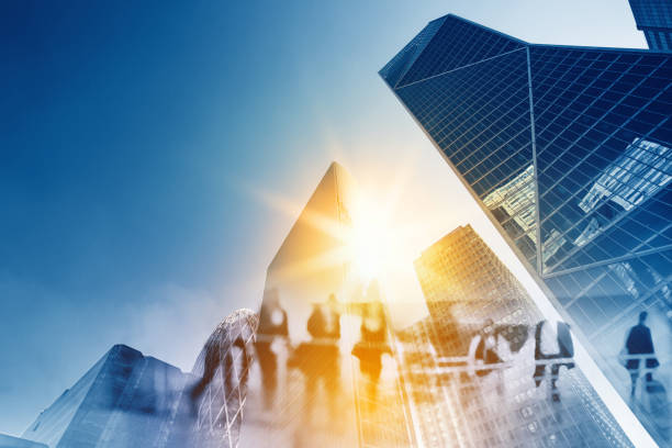 Multiple exposure of Silhouettes of people walking in the street near skyscrapers and modern office buildings in Paris business district. Multiple exposure blurred image. Economy, finances, business concept illustration Paris business district La Defense. Blurred image. Economy, finances, business concept illustration. planned economy stock pictures, royalty-free photos & images