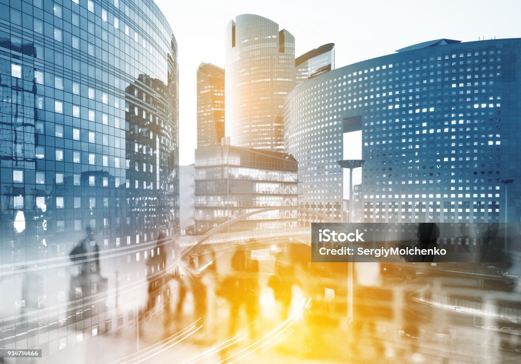 Multiple exposure of Silhouettes of people walking in the street near skyscrapers and modern office buildings in Paris business district. Multiple exposure blurred image. Economy, finances, business concept illustration Paris business district La Defense. Blurred image. Economy, finances, business concept illustration. City Stock Photo