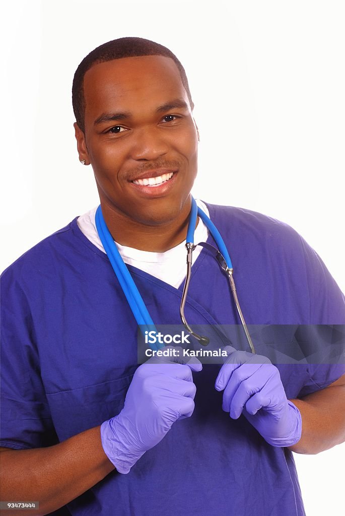 Male nurse wearing stethoscope and blue latex gloves Young male African American medical professional isolated on white background Male Nurse Stock Photo