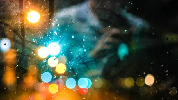 Photo of Traffic blur light bus window with passenger reflection, city life