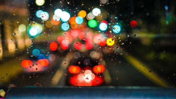 istock Blur urban traffic light rain drops on window high angle 934751844
