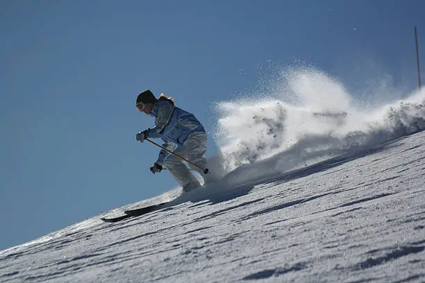 Young skier comes down very fast.