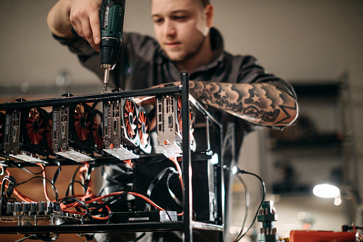 Gpu Engineer Young Engeneer Making Gpu Setup For Cryptocurrency Stock Photo ...