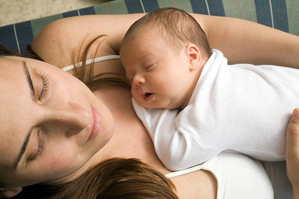 istock Mother relaxing with her newborn baby 93477041