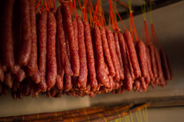 istock Fresh and dried Chinese sausages hang from racks 934782368