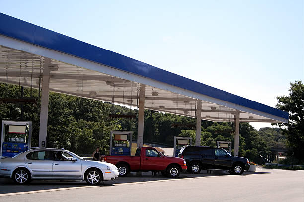 Three cars filling up at a petrol station stock photo