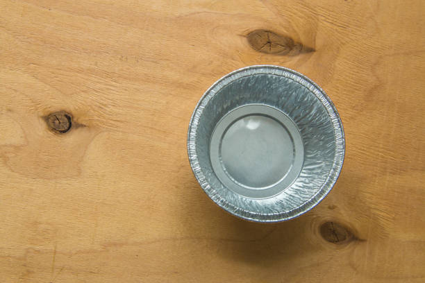 istock Aluminium cupcake mold on wooden board. 934794902