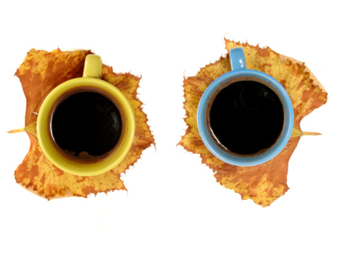 Two cup of coffee, Each one on the yellow leaf