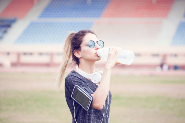 istock Young sportive woman drinking water at sunset 934795948