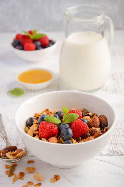 istock Homemade granola with fresh berries, milk and honey. 934799862
