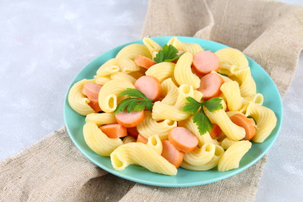 istock Pasta Cavatappi or Cellentani with sausages on a gray table. 934799946