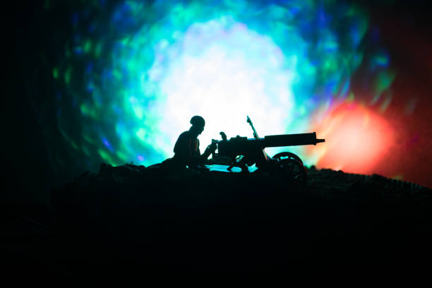 istock Man with Machine gun at night, fire explosion background or Military silhouettes fighting scene on war fog sky background, World War Soldiers Silhouettes Below Cloudy Skyline At night. 934806982
