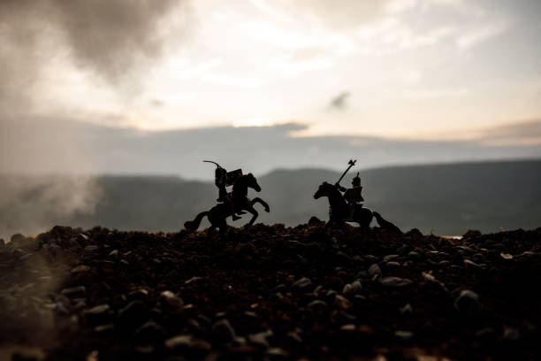 istock Joust between two knights on horseback. Sunset on background. Selective focus 934807278