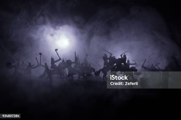 Medieval Battle Scene With Cavalry And Infantry Silhouettes Of Figures As Separate Objects Fight Between Warriors On Dark Toned Foggy Background Night Scene Stock Photo - Download Image Now