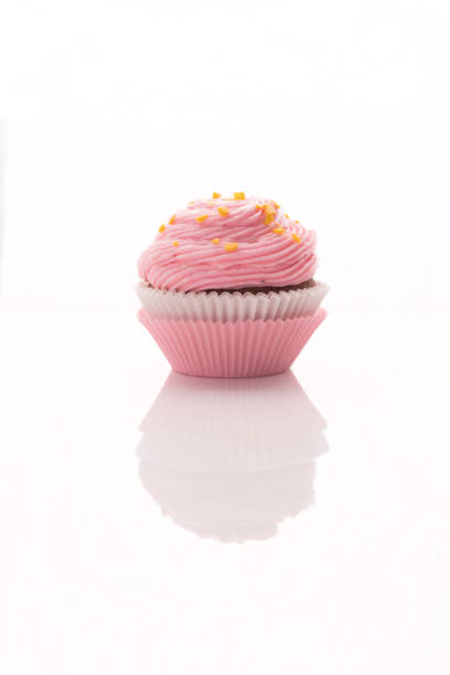 Delicious pink cupcake on a white background isolated