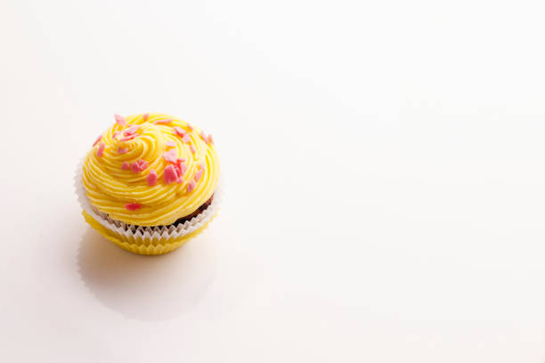 istock Delicious yellow cupcake on a white background 934812692