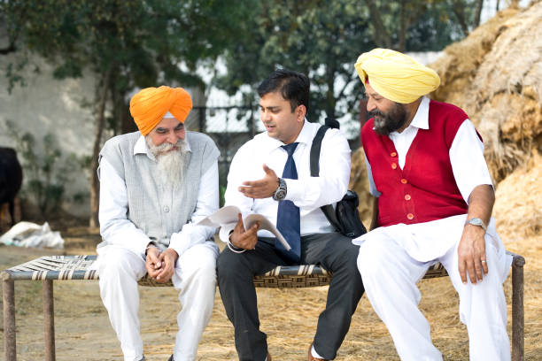 istock Salesperson explaining contract to farmers 934822770