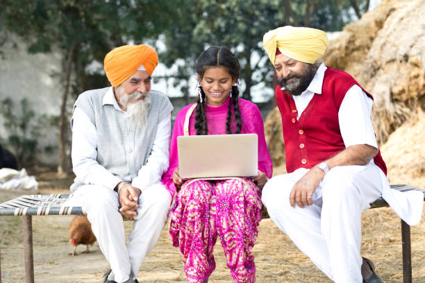 istock Indian men with girl using laptop 934822856