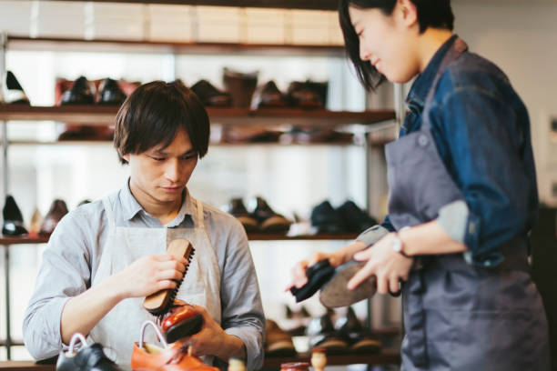 istock Woman teaching new worker how to polish shoes 934823334
