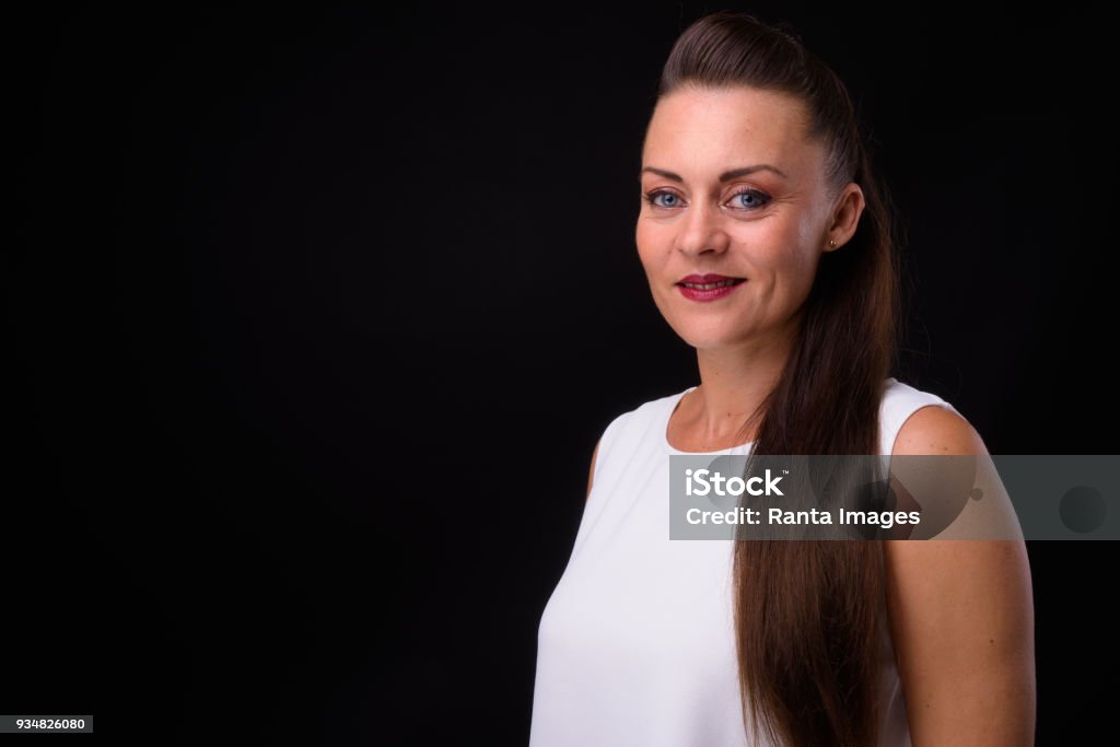 Portrait Of Woman Against Black Background Studio Portrait Of Happy Woman Against Black Background 35-39 Years Stock Photo