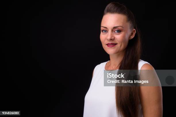 Portrait Of Woman Against Black Background Stock Photo - Download Image Now - 35-39 Years, 40-44 Years, Adult