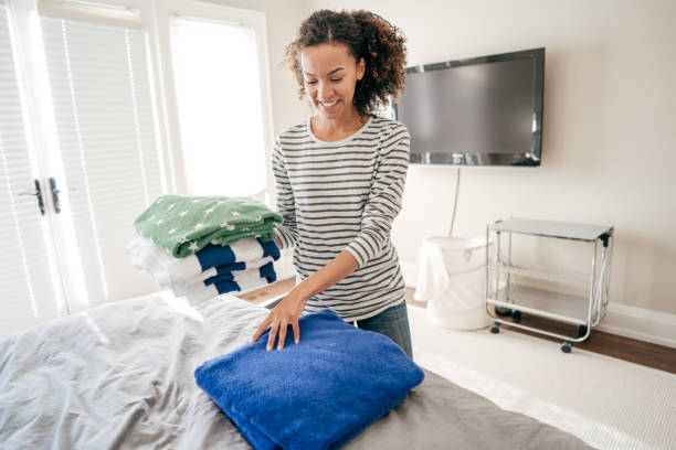 istock Woman folding towels 934828914