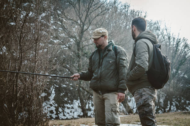 istock Two men talking and fishing. 934839732