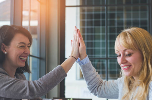 istock teamwork concept of attractive young woman with high five hands bump for relationship friendship together. 934840106