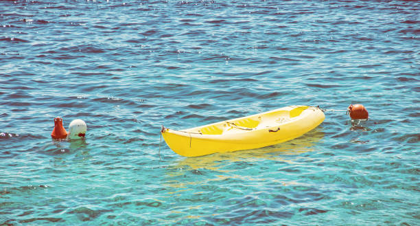 istock Anchored yellow kayak in Maslinica, Solta, retro filter 934840264
