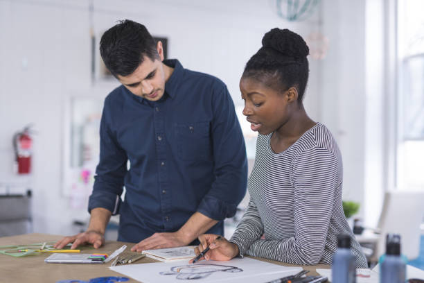 istock Design couple strategize in their modern studio 934843400