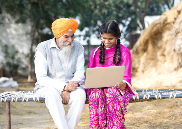 istock Old man with girl using laptop 934847104