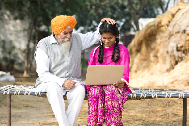 istock Old man with girl using laptop 934847142